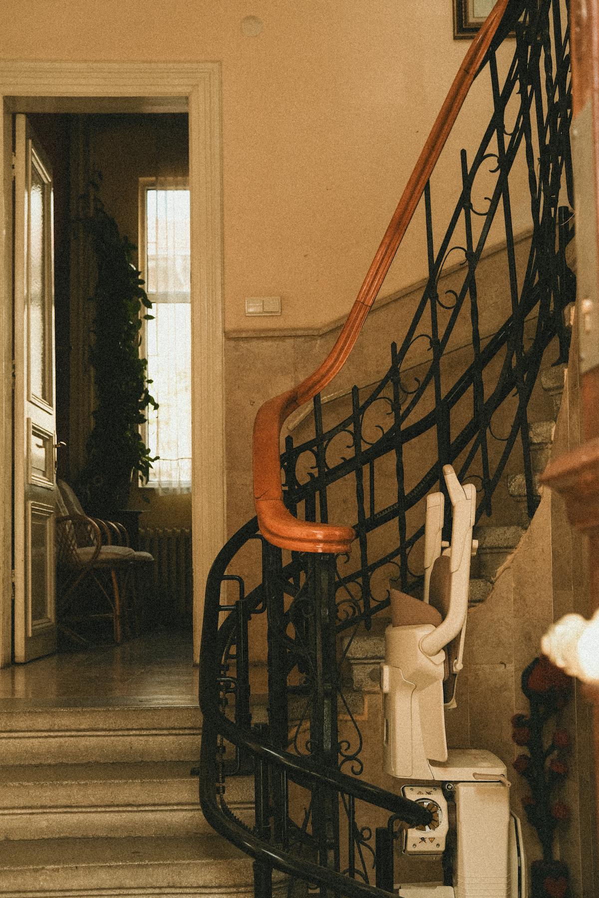 A stairlift installed along a staircase railing in a home