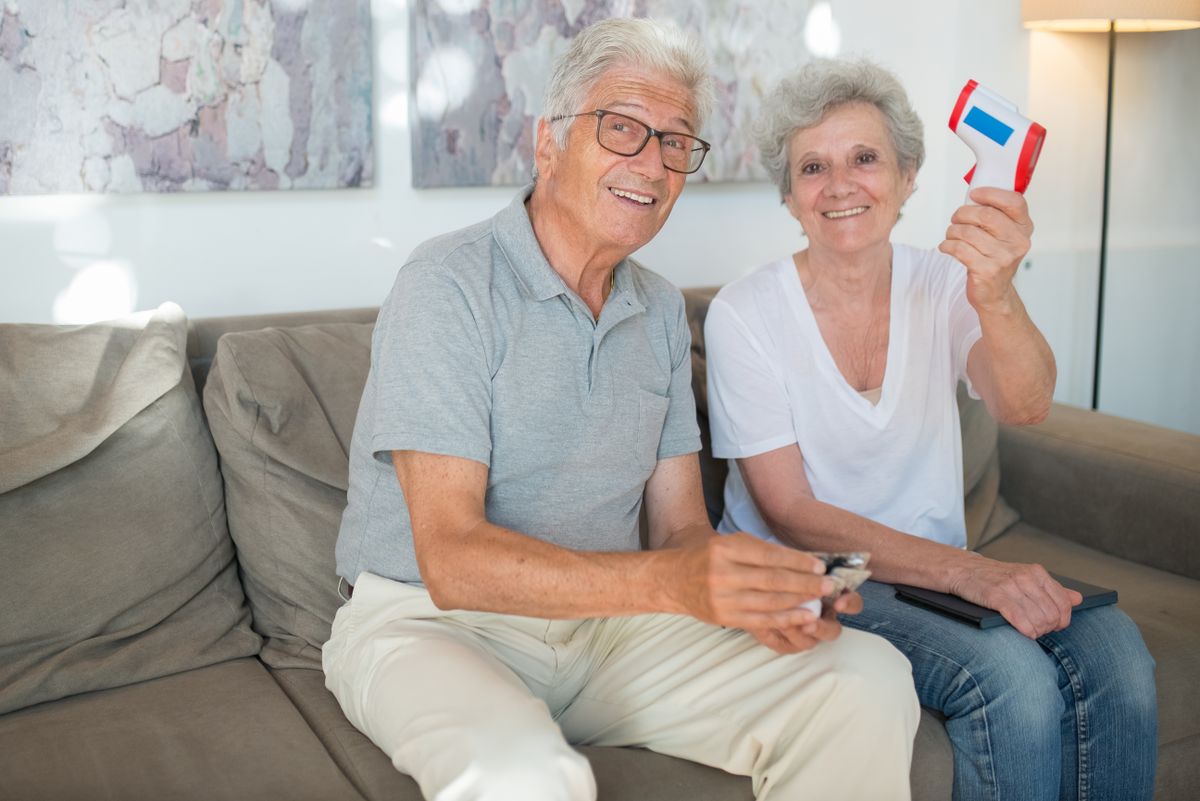Happy senior couple at home | Stairlift Guru Happy senior couple sitting together at home