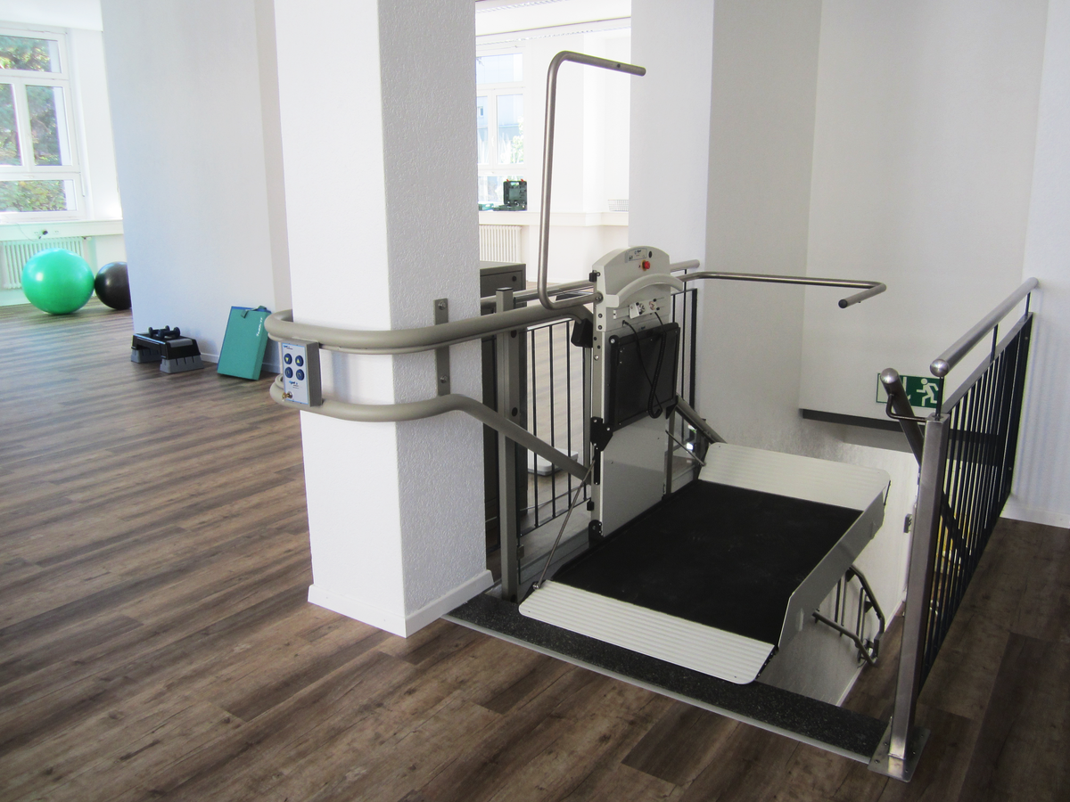 Platform lift installed at the bottom of a staircase