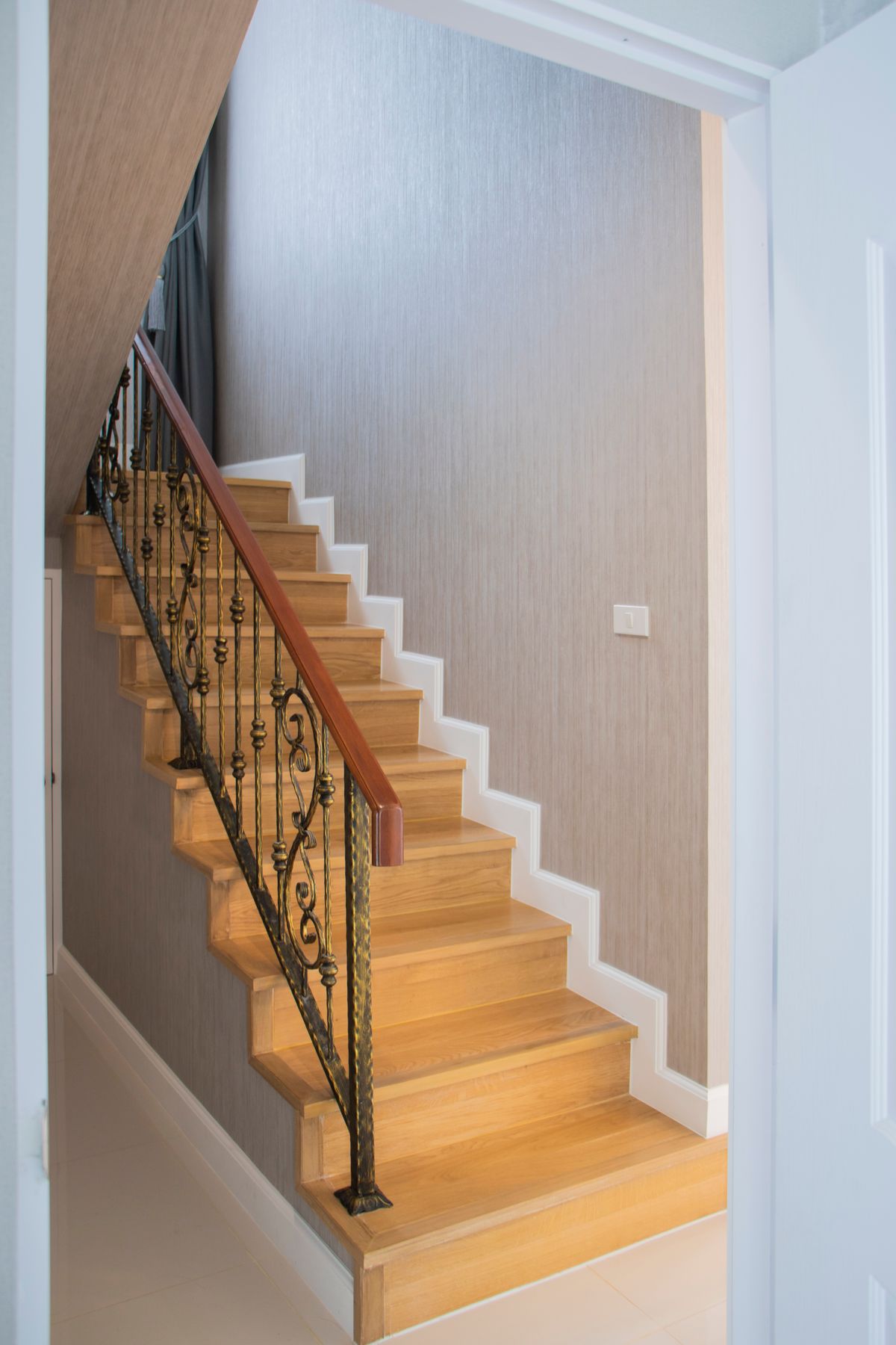 Straight staircase with wooden handrail | Stairlift Guru Straight domestic staircase with a wooden handrail