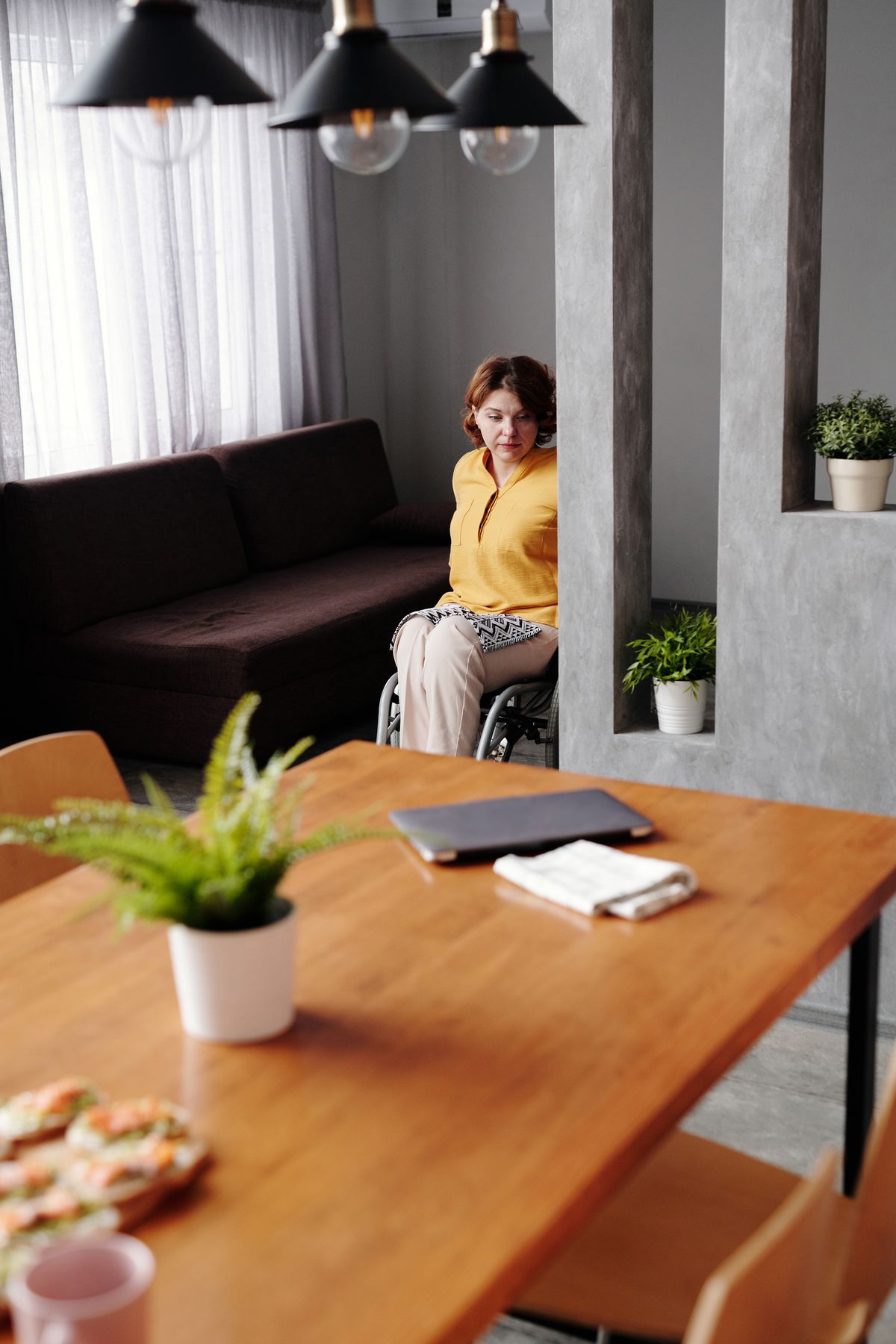 Wheelchair user at home | Stairlift Guru Wheelchair user at a table in an accessible home