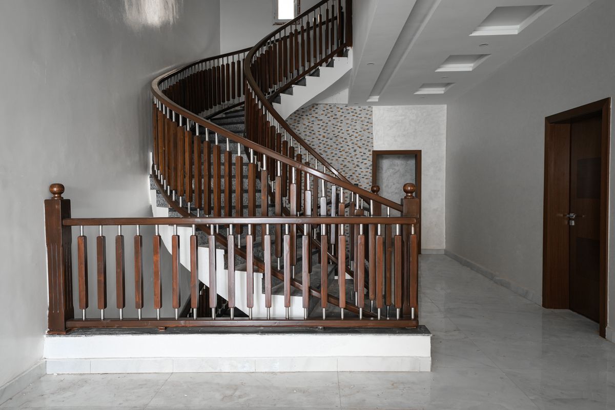 A curved wooden staircase in a home A curved wooden staircase in a home