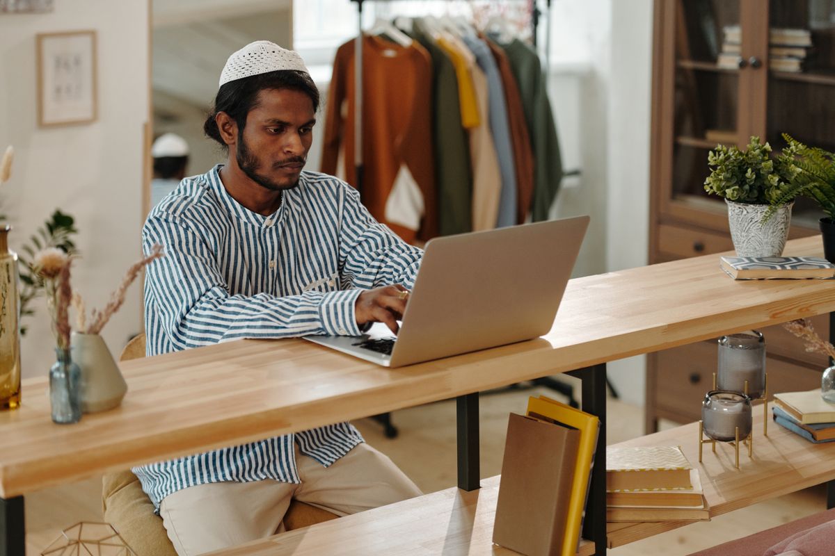 A man using a laptop at a table at home