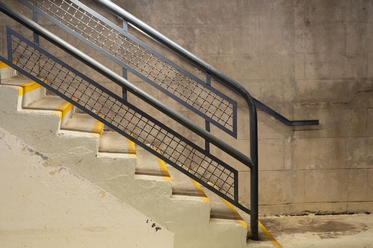 A metal handrail beside outdoor steps