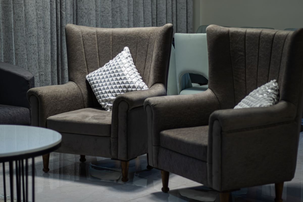 A pair of high-backed armchairs in a living room
