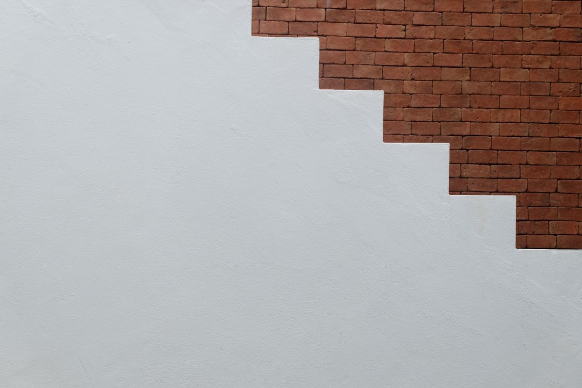 A plain staircase against a brick wall A plain staircase against a brick wall