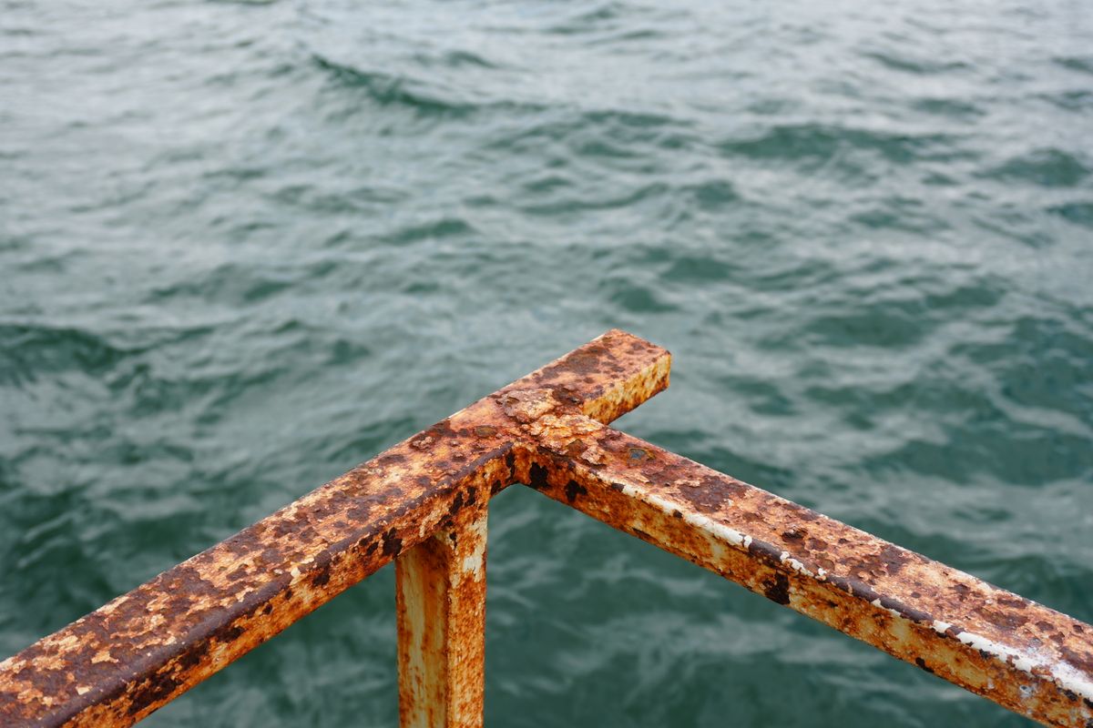 A rusted metal railing A rusted metal railing