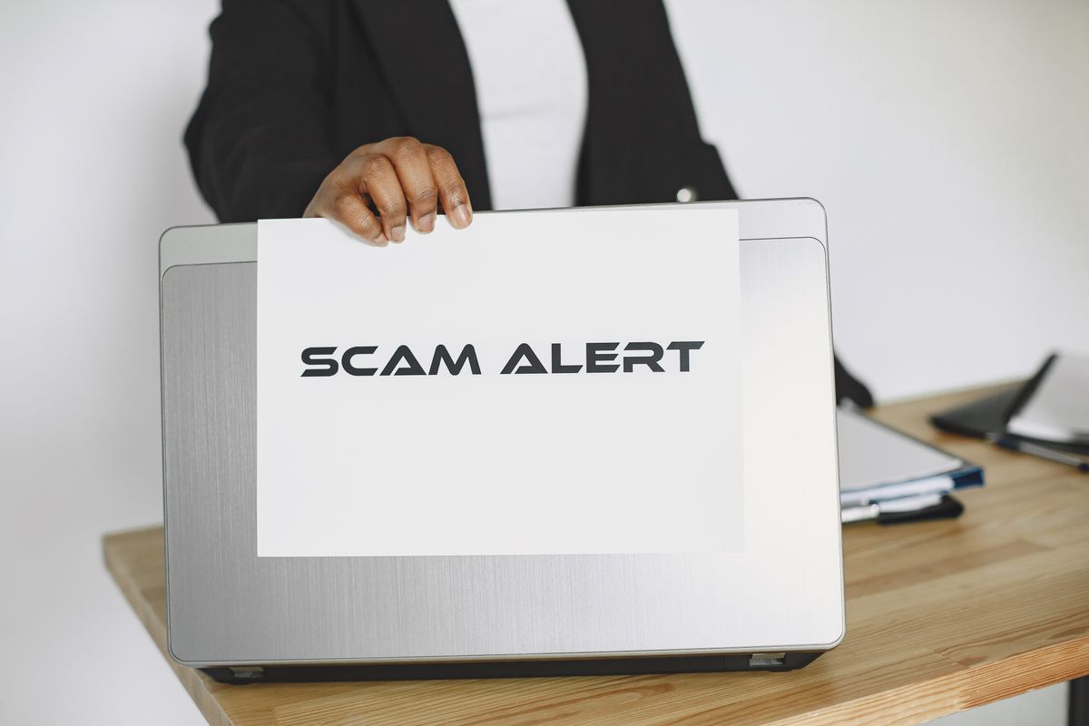 A scam alert warning on a desk A scam alert warning on a desk