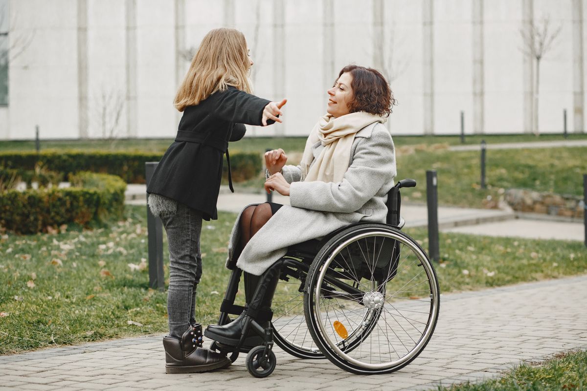 A wheelchair user outdoors on a path