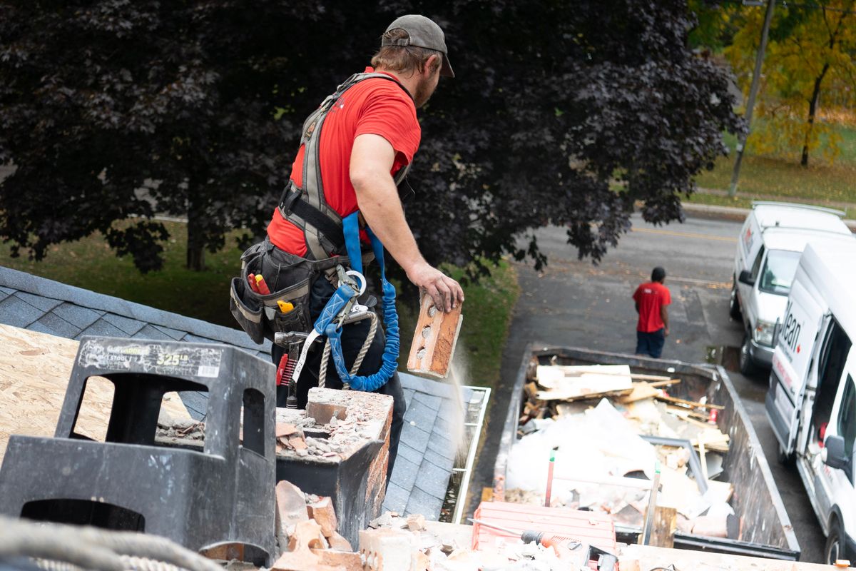 A worker loading material into a van A worker loading material into a van