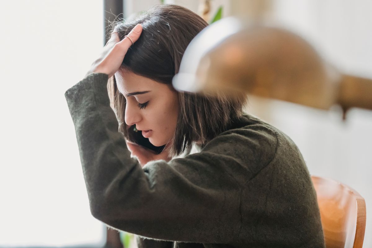 A worried woman on the phone at home A worried woman on the phone at home