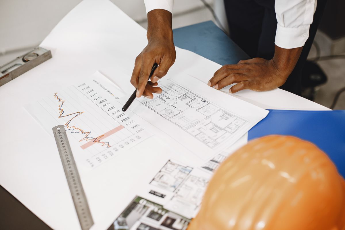 Architectural plans and a hard hat