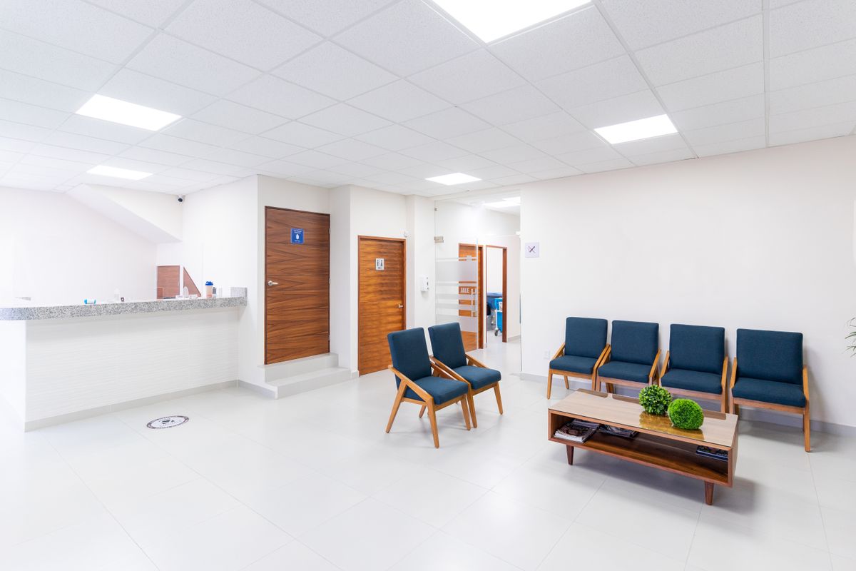 An empty waiting area with rows of chairs