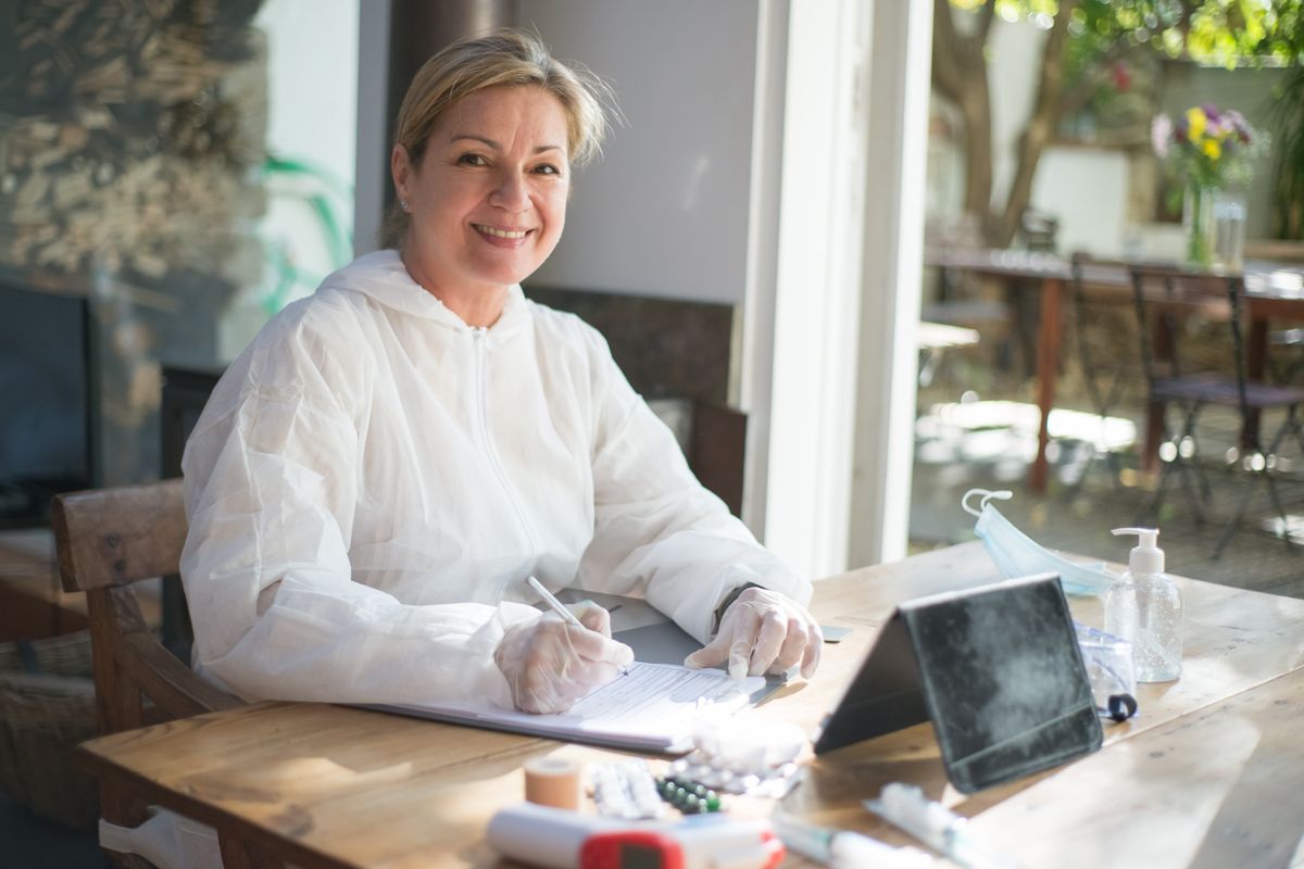 A healthcare professional making notes at a table