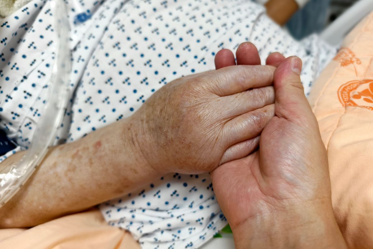 Holding hands at a bedside