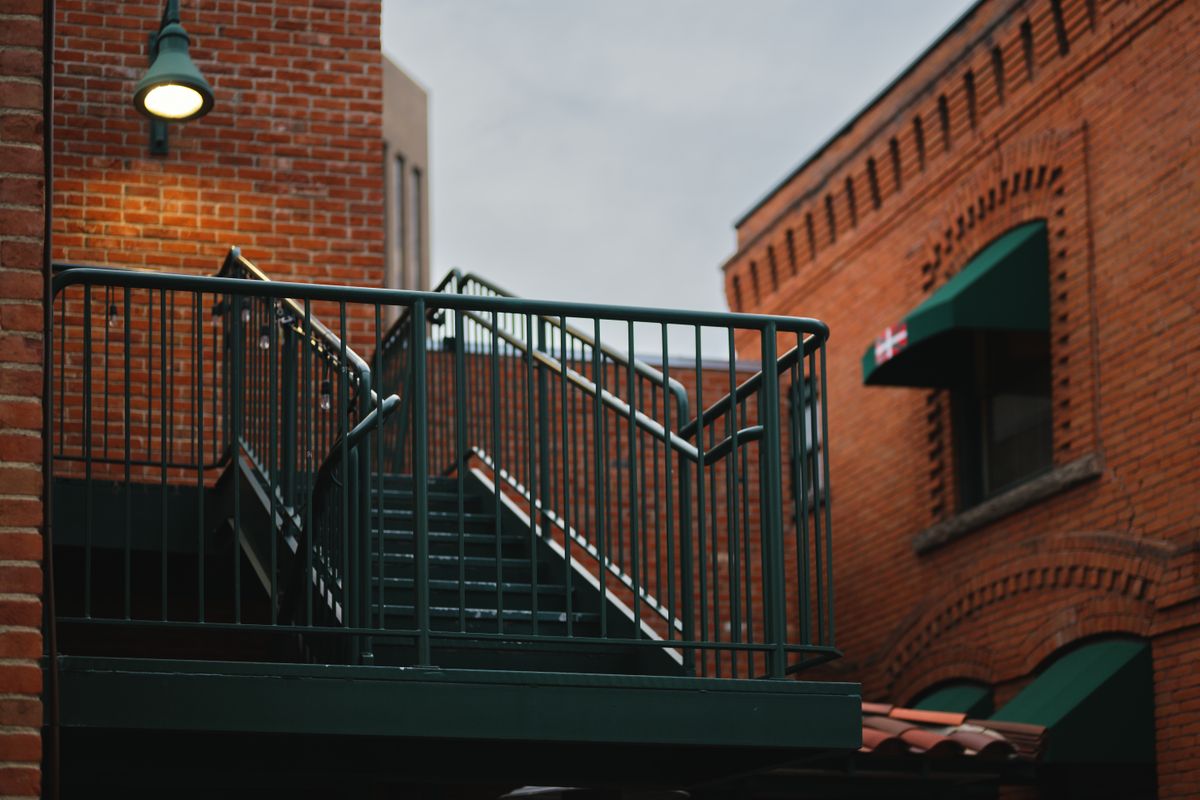 A metal handrail running along a staircase A metal handrail running along a staircase