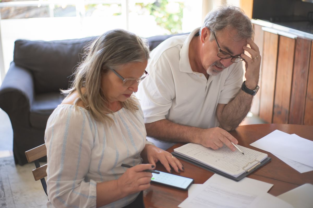 An older couple planning their budget at home An older couple planning their budget at home