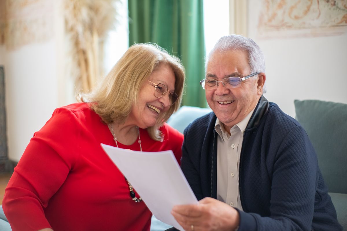 An older couple reading documents together An older couple reading documents together