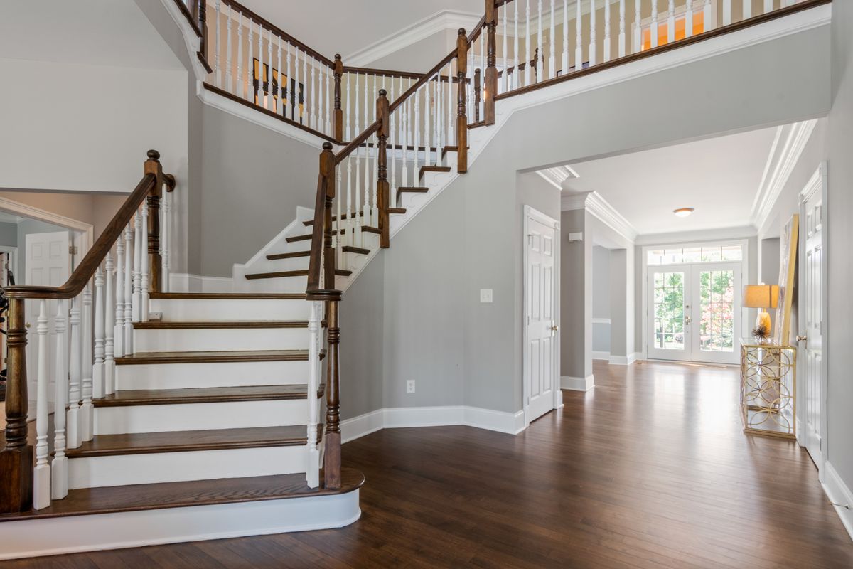 A staircase and hallway in a house A staircase and hallway in a house