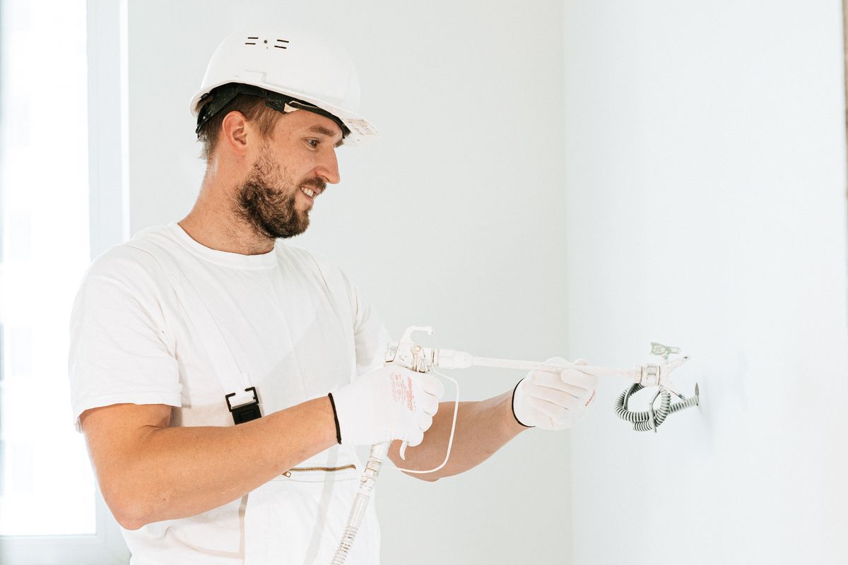 A technician fitting equipment to a wall