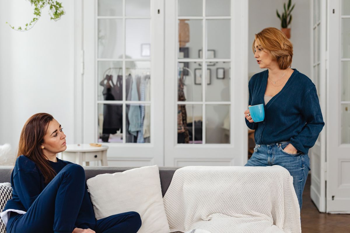 Two women having a serious conversation in a living room