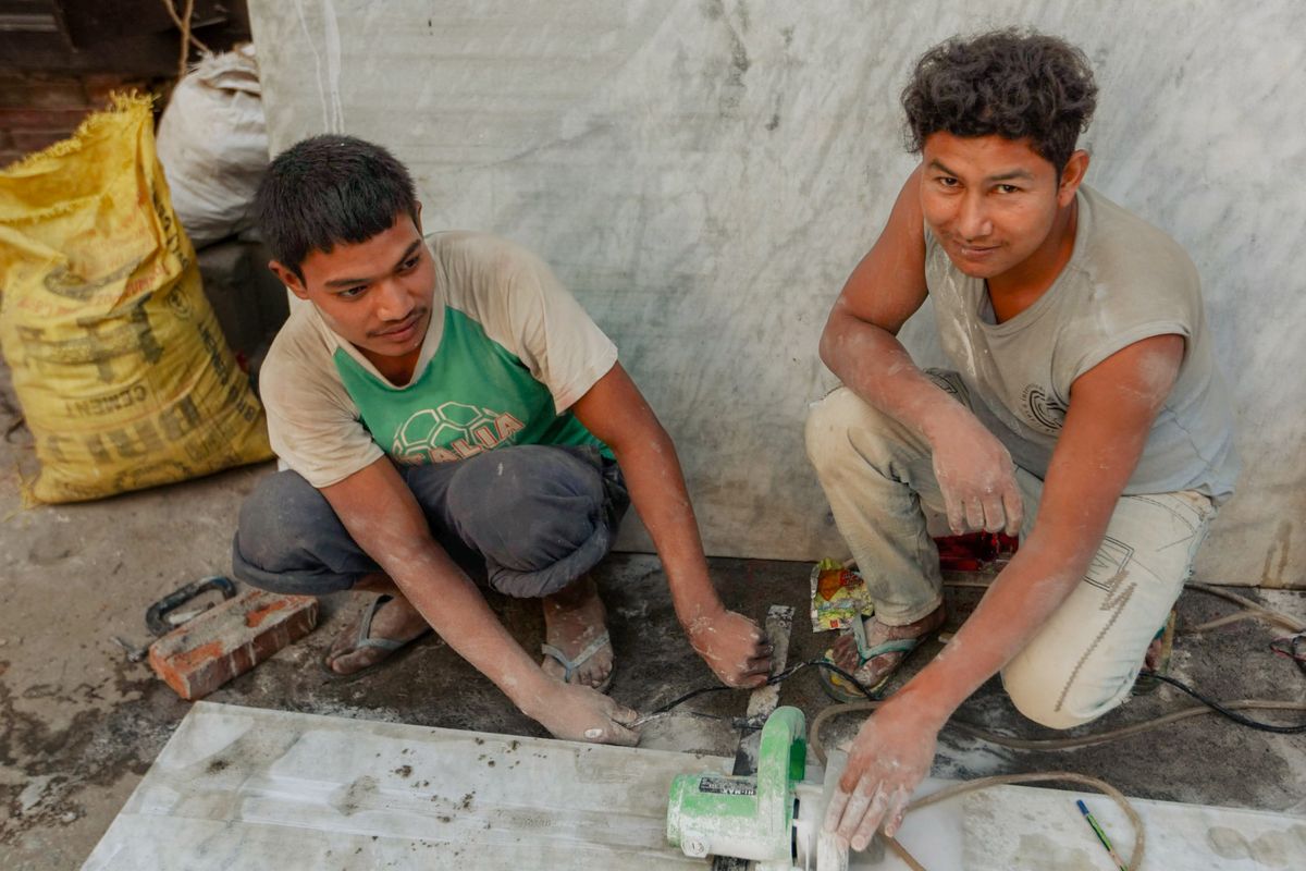 Two workmen at work on a floor Two workmen at work on a floor