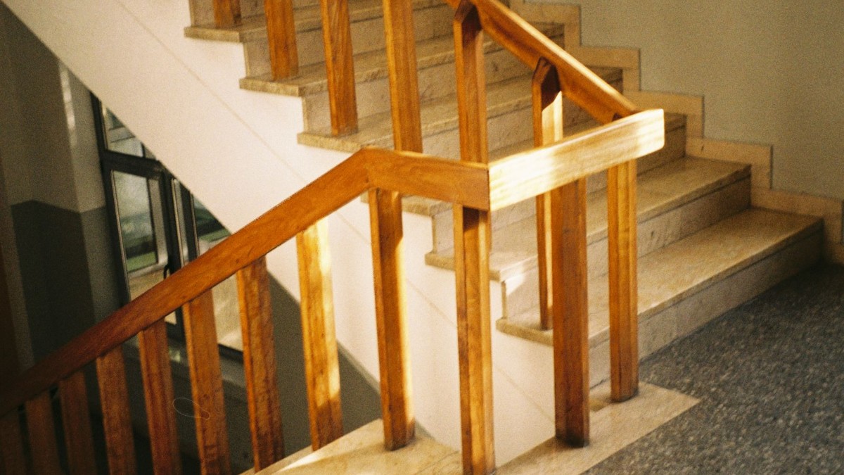 Accessible home staircase with handrail A staircase with a wooden handrail inside a home