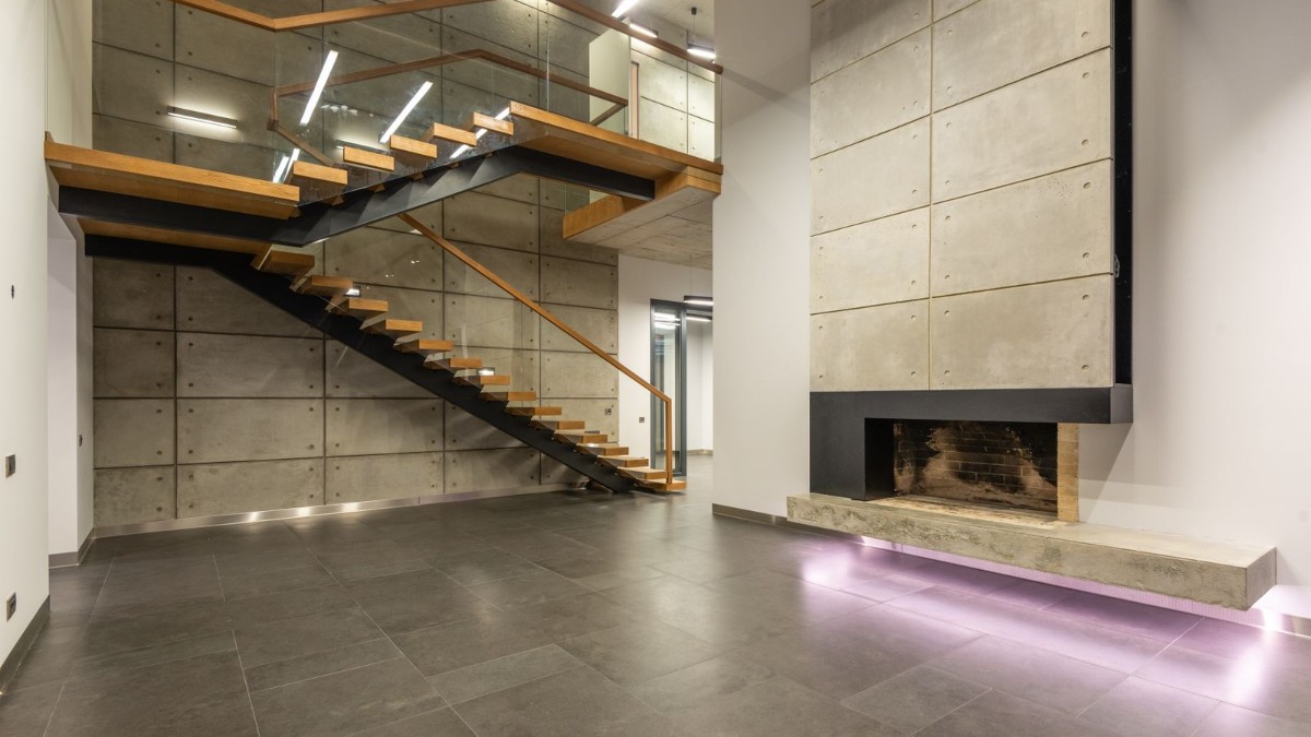 A modern home interior with a minimalist staircase and handrail