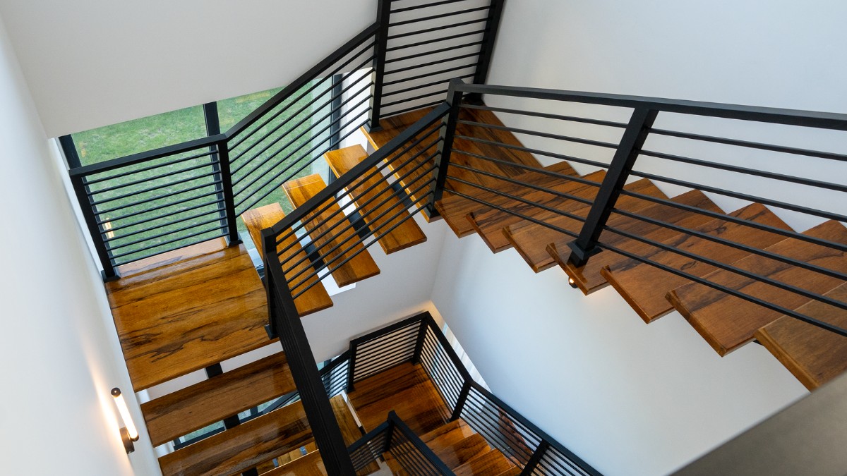 Home staircase with handrail A domestic staircase with a wooden handrail in a home